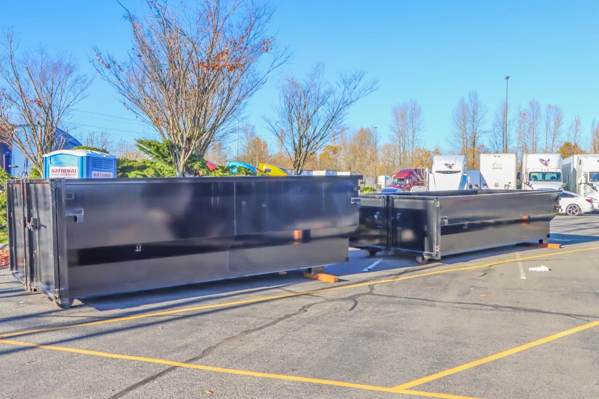 Professional dumpster rental service with roll-off container on residential driveway in Monticello